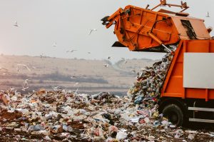 Garbage truck dumping the garbage on a landfill